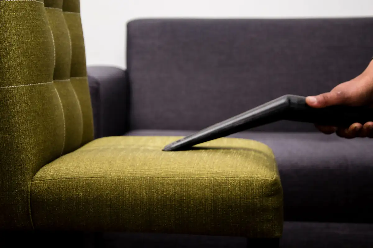 Armchair upholstery cleaning | Carpet cleaning in Newcastle Upholstery tool cleaning the seat of a green fabric armchair, upholstery cleaning in Newcastle